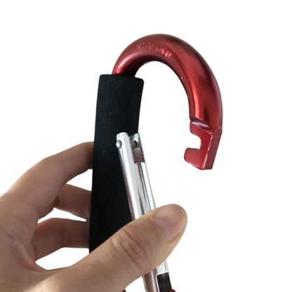 Red carabiner with a black clip held by a hand on a white background