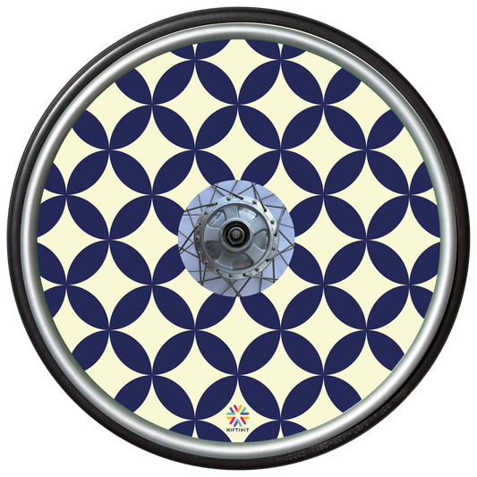 Wheelchair wheel with navy blue and cream geometric petals and diamonds pattern on a spoke guard cover with centre hub cutout. 