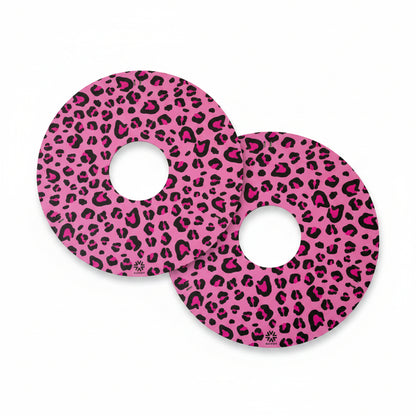 Pair of Niftikit pink and black leopard print wheelchair wheel covers against a white background 