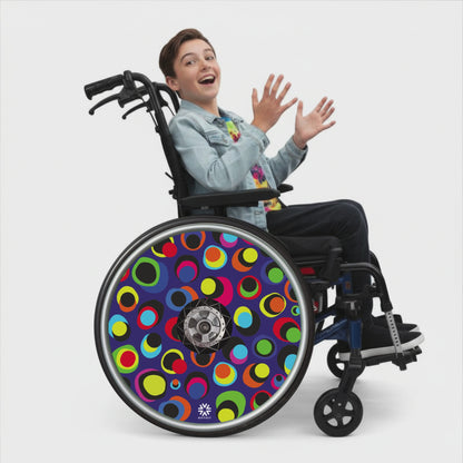 Wheelchair with rotating colourful dot pattern spoke guard covers in bright multicolour circles on a dark blue background, Niftikit Gone Dotty design