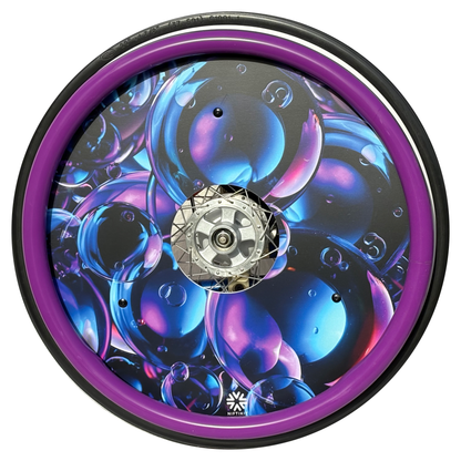 Wheelchair wheel featuring a purple silicone hand rim cover and spoke guard with blue pink and purple giant bubbles on a black background